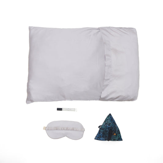 Nyana x Sukhatara Unwind Kit featuring a natural dye batik tulis silk eye mask and premium aromatherapy oil in a sustainable gift set.