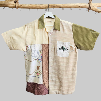 Close-up of artisanal embroidery featuring traditional Kopi and Karipap motifs on a premium sustainable cotton shirt.