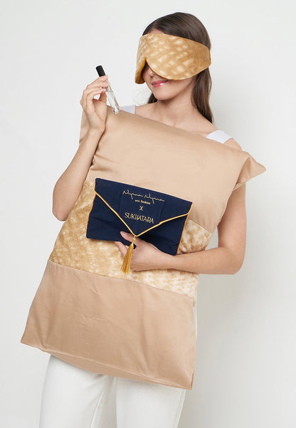 Nyana x Sukhatara Unwind Kit featuring a natural dye batik tulis silk eye mask and premium aromatherapy oil in a sustainable gift set.