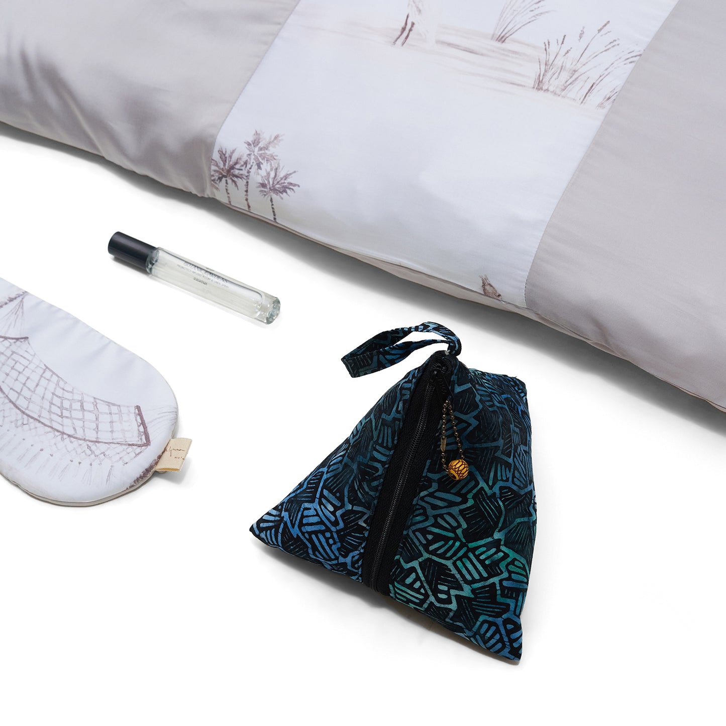 Nyana x Sukhatara Unwind Kit featuring a natural dye batik tulis silk eye mask and premium aromatherapy oil in a sustainable gift set.