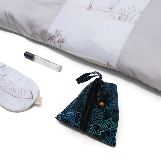 Nyana x Sukhatara Unwind Kit featuring a natural dye batik tulis silk eye mask and premium aromatherapy oil in a sustainable gift set.