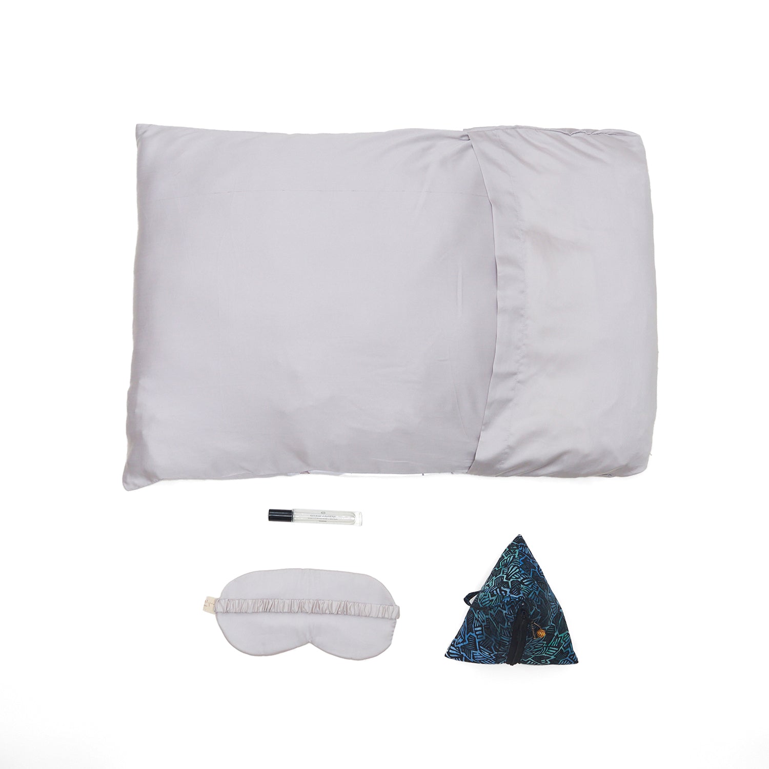 Nyana x Sukhatara Unwind Kit featuring a natural dye batik tulis silk eye mask and premium aromatherapy oil in a sustainable gift set.