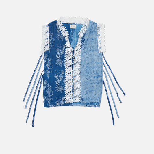 Close-up of hand-drawn batik tulis details on a sleeveless cotton kebaya vest with natural plant-based dye.