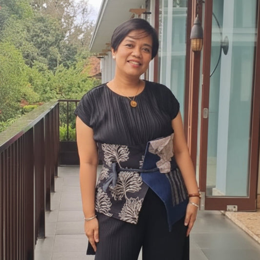 Women's sustainable obi belt featuring hand-drawn batik tulis patchwork and colorful artisanal embroidery accents.