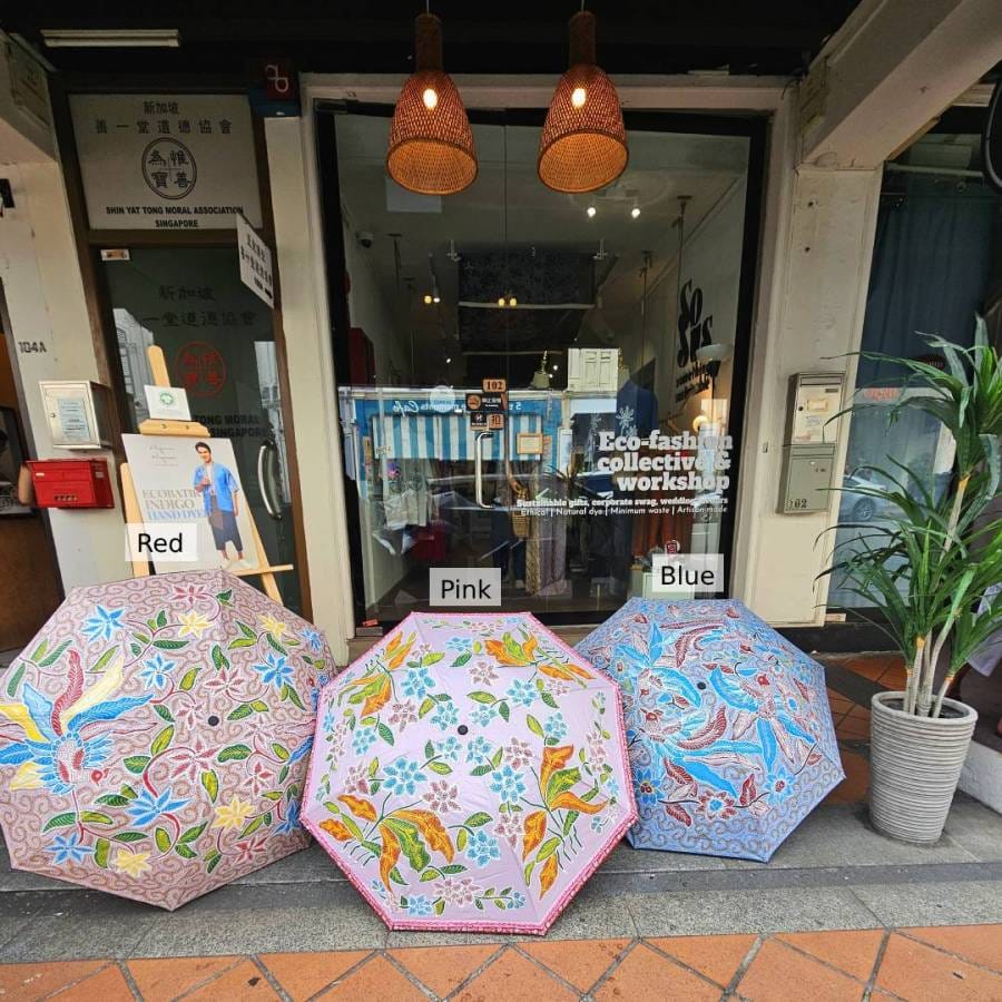 Hand-drawn Peranakan batik tulis umbrella with UV protection coating, featuring vibrant floral motifs for sun and rain protection.