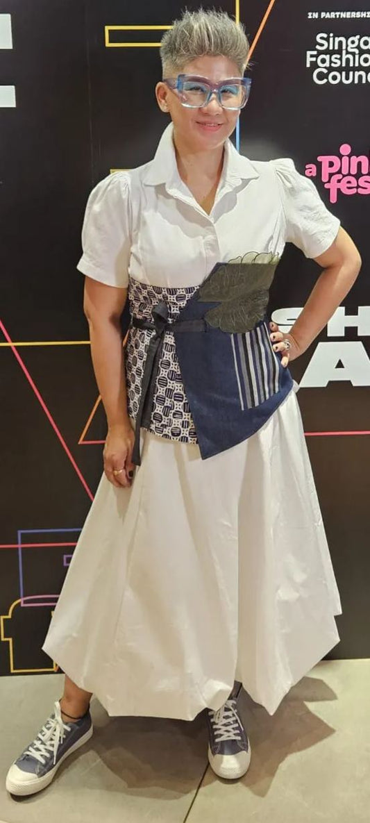 Women's sustainable obi belt featuring hand-drawn batik tulis patchwork and colorful artisanal embroidery accents.